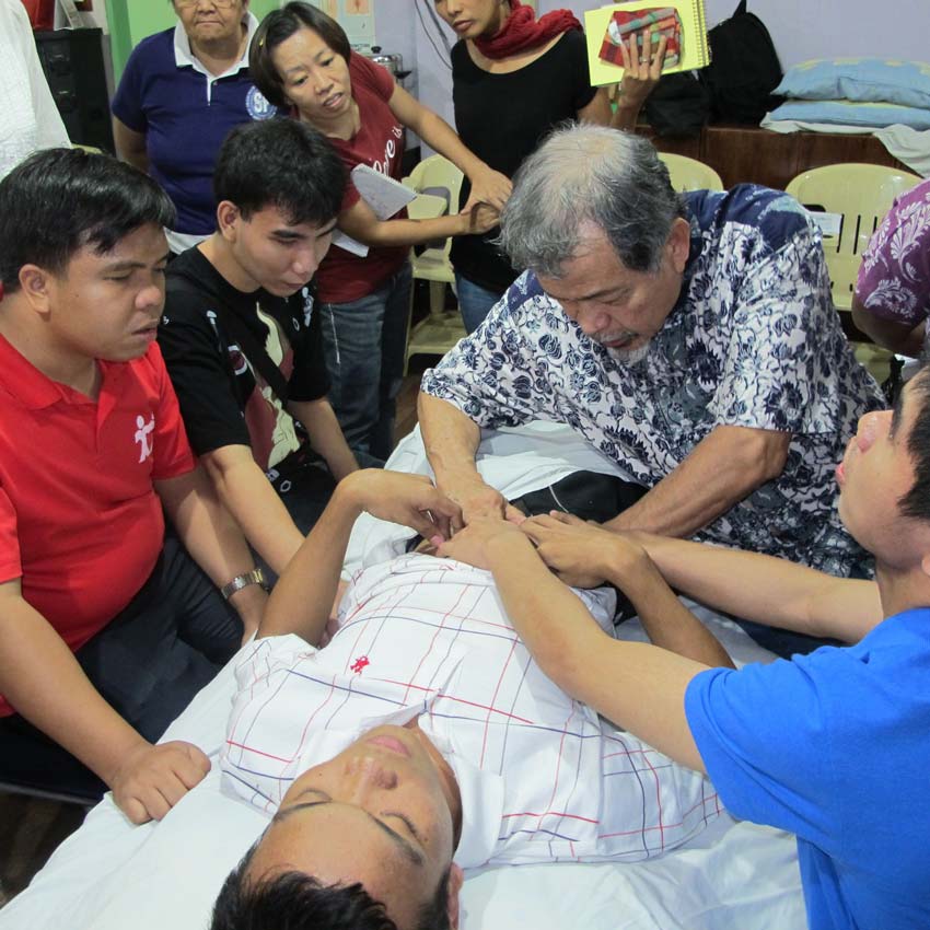 A special seminar was held for blind masseurs in 2013. You can not teach the blind by just describing the technique. Here I am demonstrating a technique with several hands on mine. It is the best way to teach people who cannot see what you are doing. 