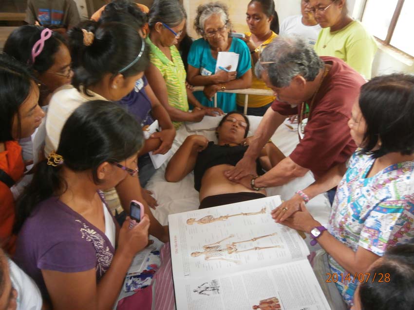  Teaching CNT internal organs massage to village women in Homonhon Island, East Samar. Homonhon was one of the islands devastated by the typhoon Haiyan/Yolanda. CNT was part of the protocol for treating trauma.